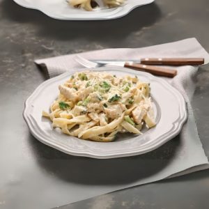 Plate with Chicken Alfredo on Table